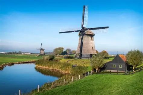 Dutch windmills surrounding by a water pond and greenery