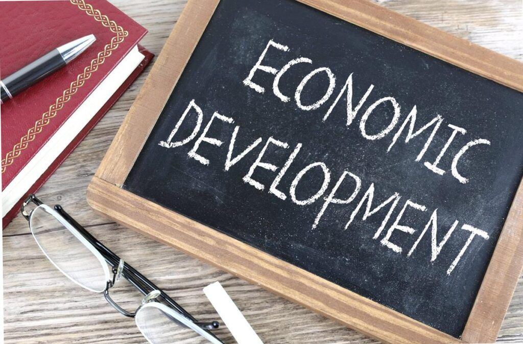 economic development text written on blackboard